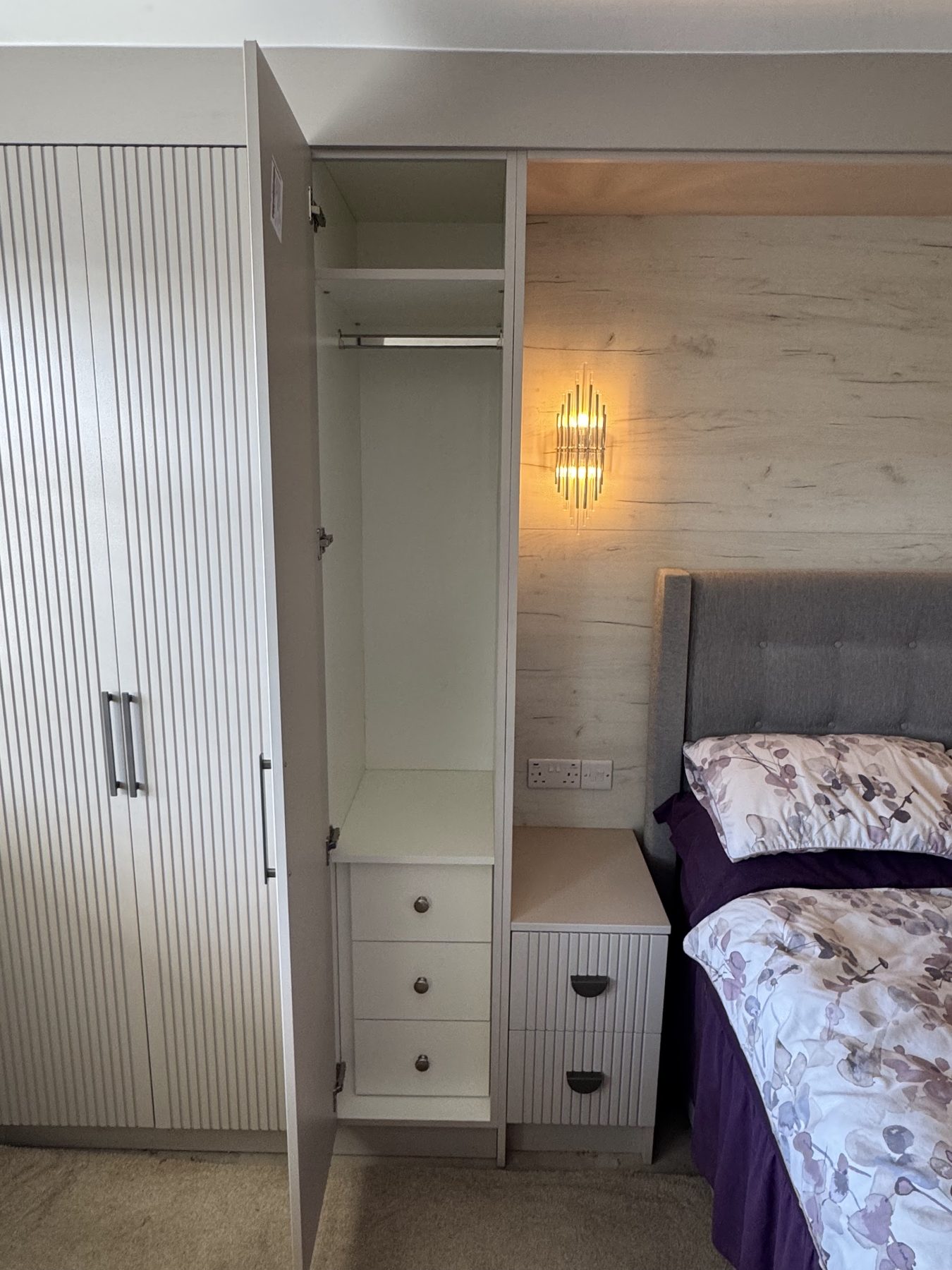 Fitted bedroom with fluted door fronts and matching bedside drawers
