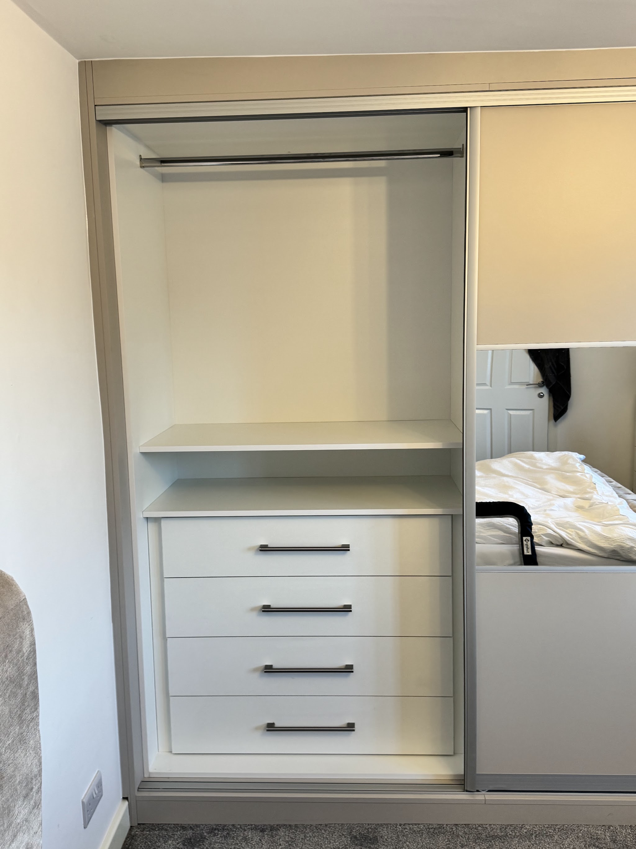 Sliding mirror door wardrobe with internal drawers and hanging rail